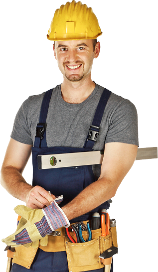 A construction worker wearing a yellow helmet and overalls, adjusting gloves with a tool belt and level.
